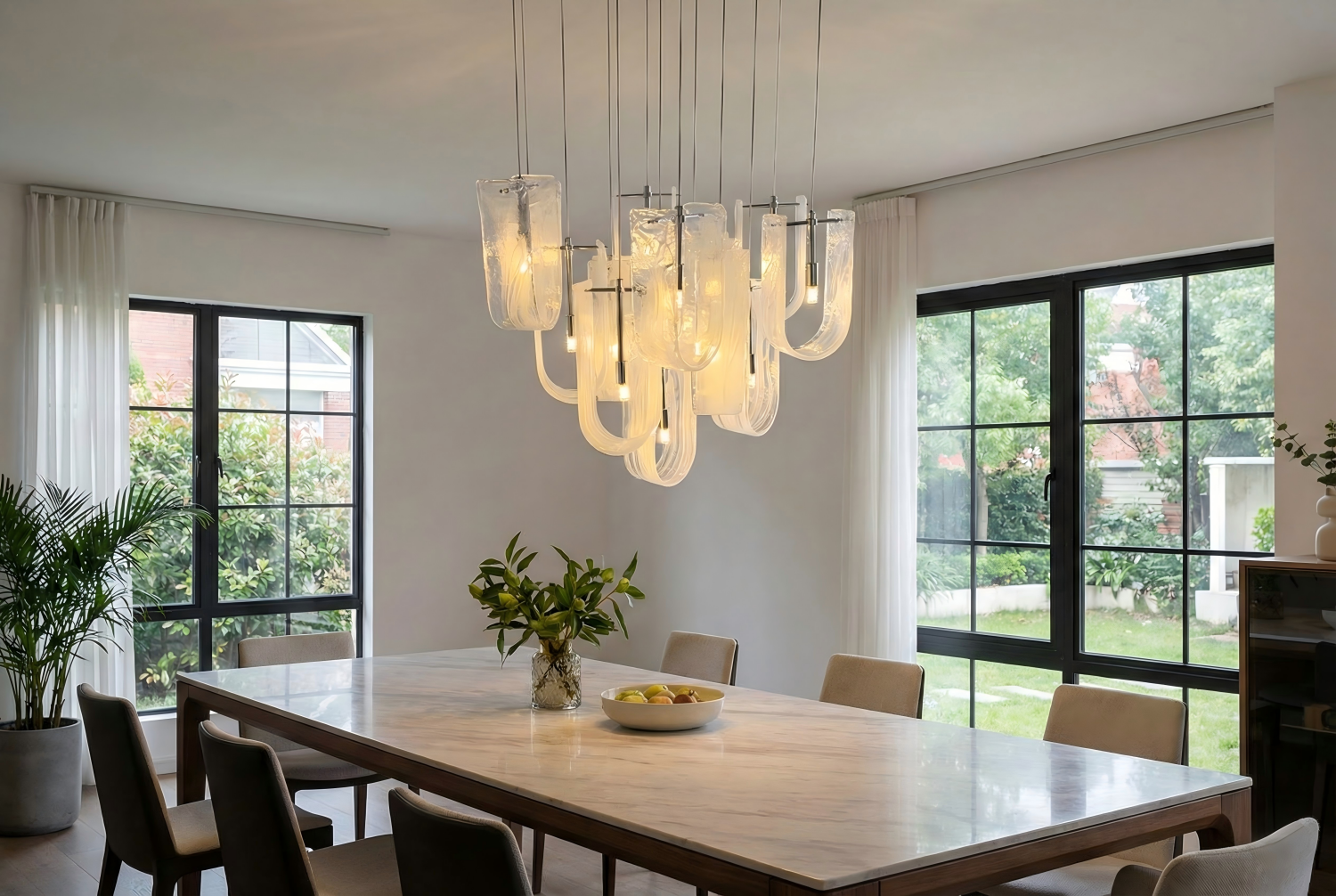 Collage of 2026 chandelier design trends showing hand-blown glass organic ceramic forms brushed gold metal and warm ambient lighting