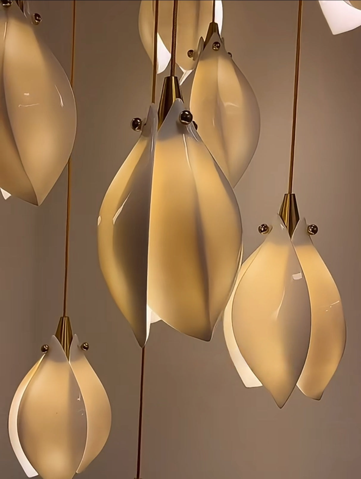 close-up view of the ceramic shades from Cluster Bloom Chandelier, illuminating the warm lighting.