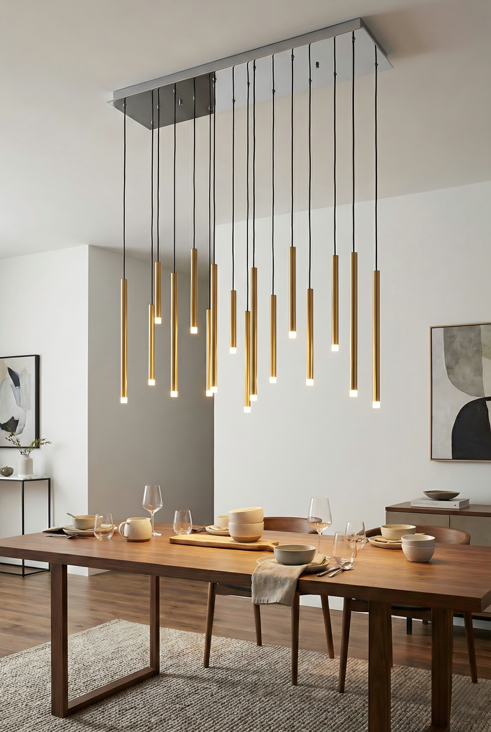 Modern dining room with a wooden table and pendant lights.