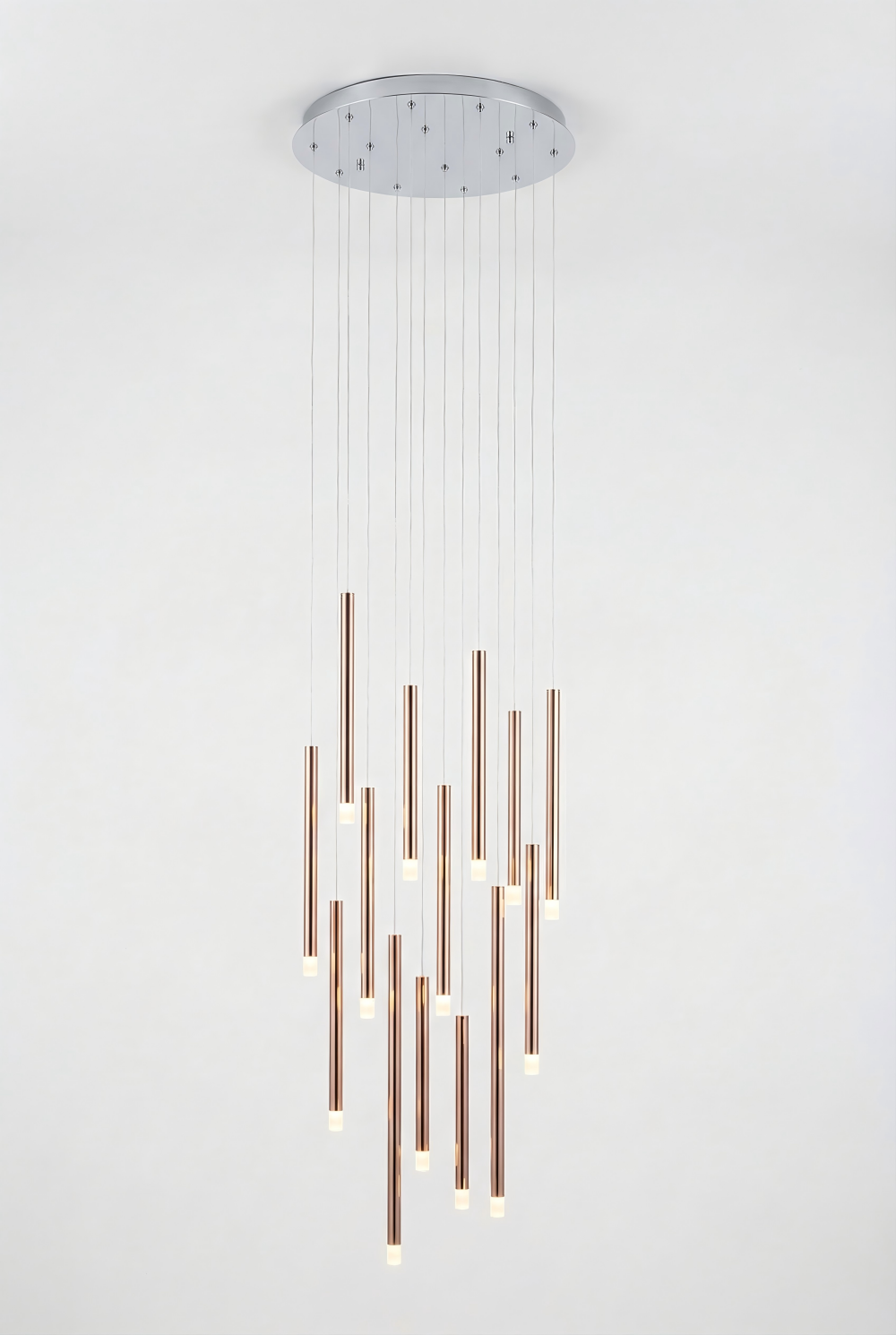 Modern pendant light fixture with cylindrical copper rods on a white background