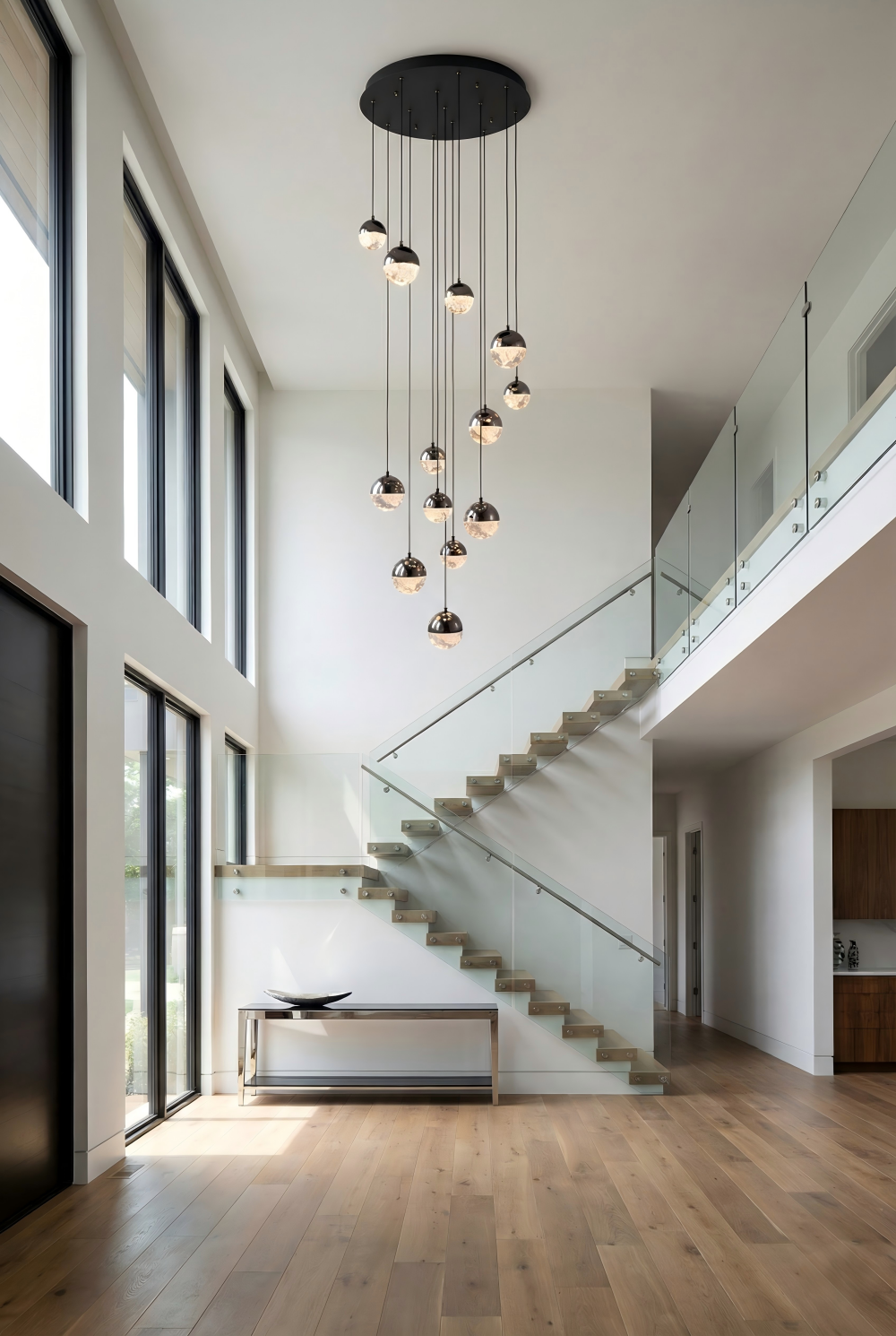 Modern staircase with pendant lights in a bright, minimalistic home interior.