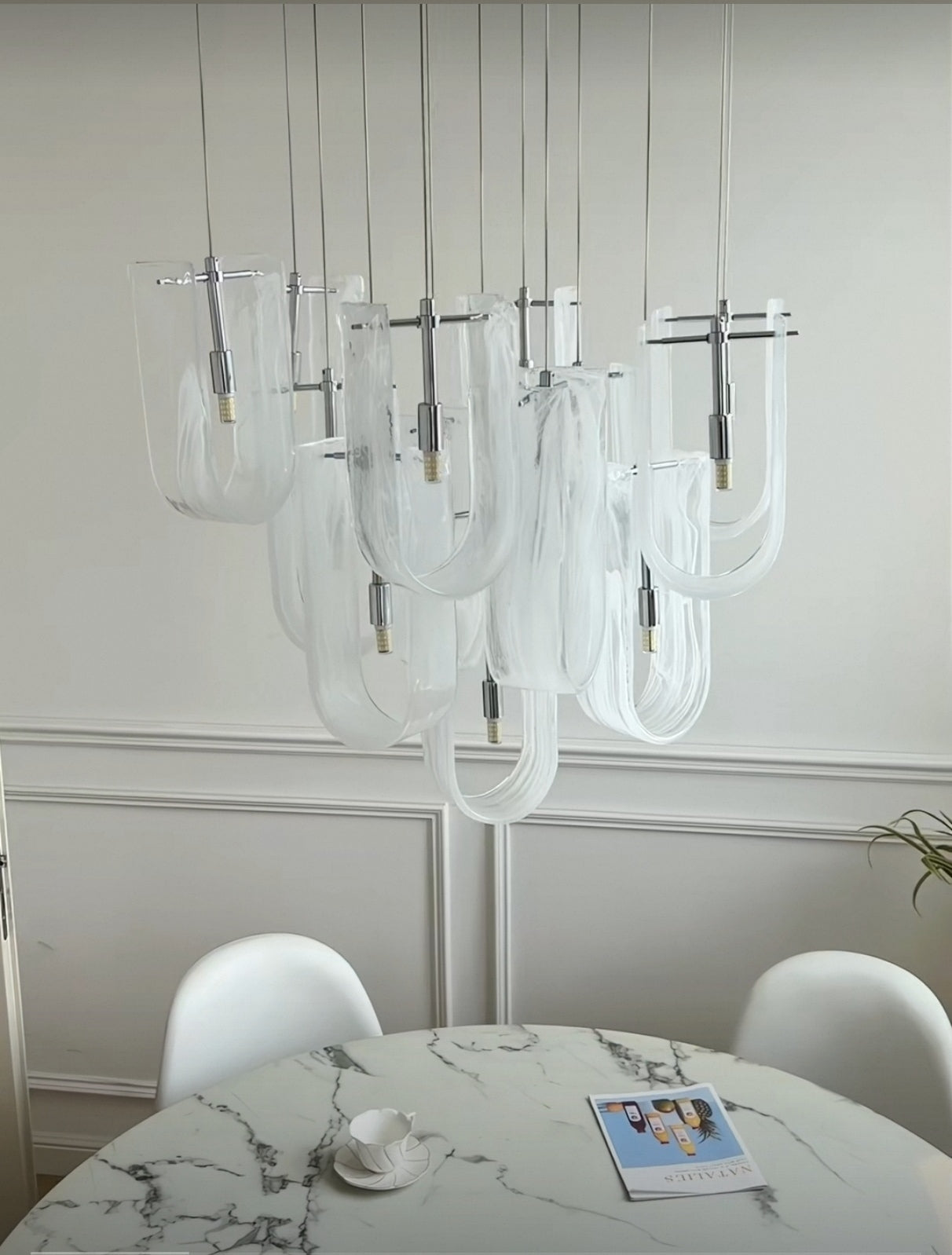 Warm ambient glow from the Luminous Waves chandelier, creating a cozy interior.