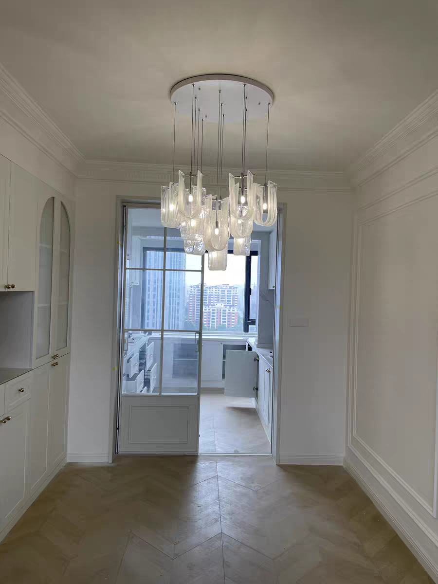 Luminous Waves Chandelier by Aurorae Lighting, viewed from a distance within a room, illustrating its scale and impact on the overall space.