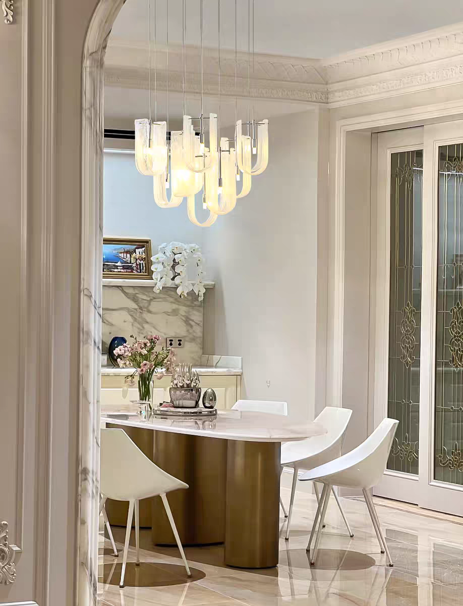 Softly lit Aurorae Lighting Luminous Waves Chandelier creating a serene atmosphere, with gentle light patterns cast on nearby surfaces.