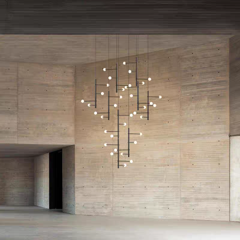 Elegant black multi-arm chandelier with opal globes, installed in a high-ceiling minimalist interior.