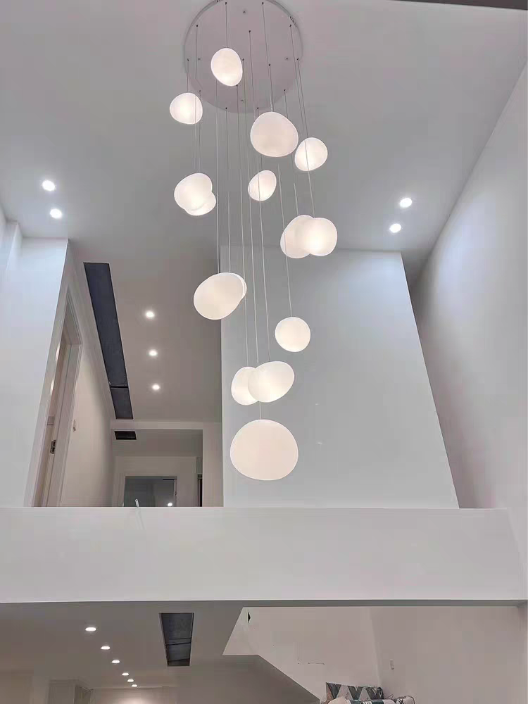 View from below of an illuminated Aurorae Lighting Pebbles pendant cluster
