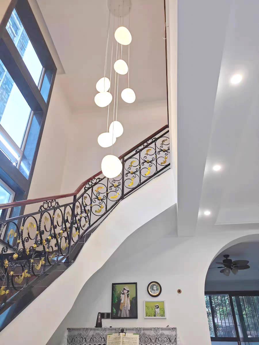 The organic, stone-like form of an Aurorae Lighting Pebbles light shade