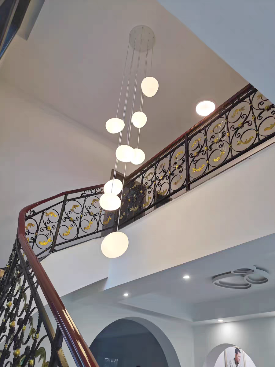 Contemporary living space accented by Aurorae Lighting Pebbles pendants