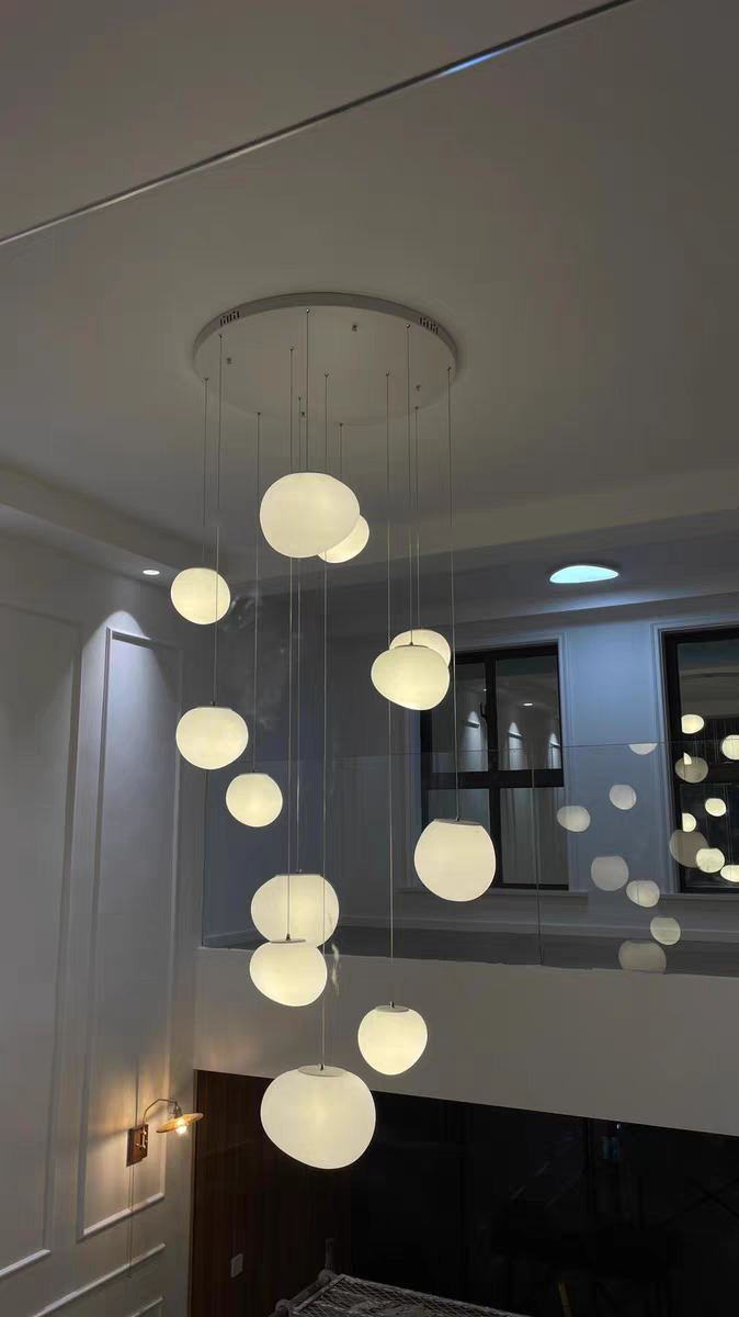 Multiple Aurorae Lighting Pebbles pendants creating a statement chandelier effect