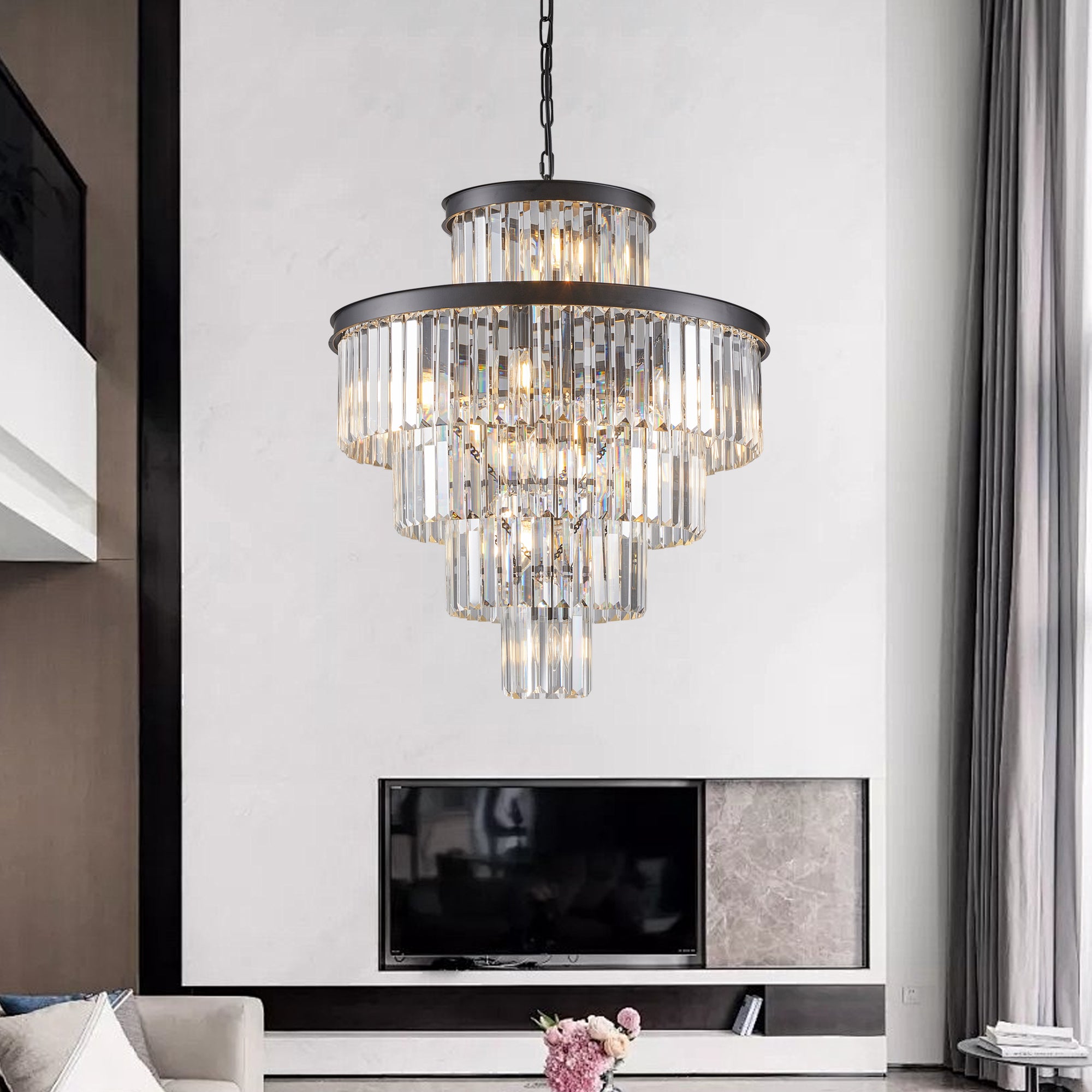 Chandelier hanging above a television in a living room setting.