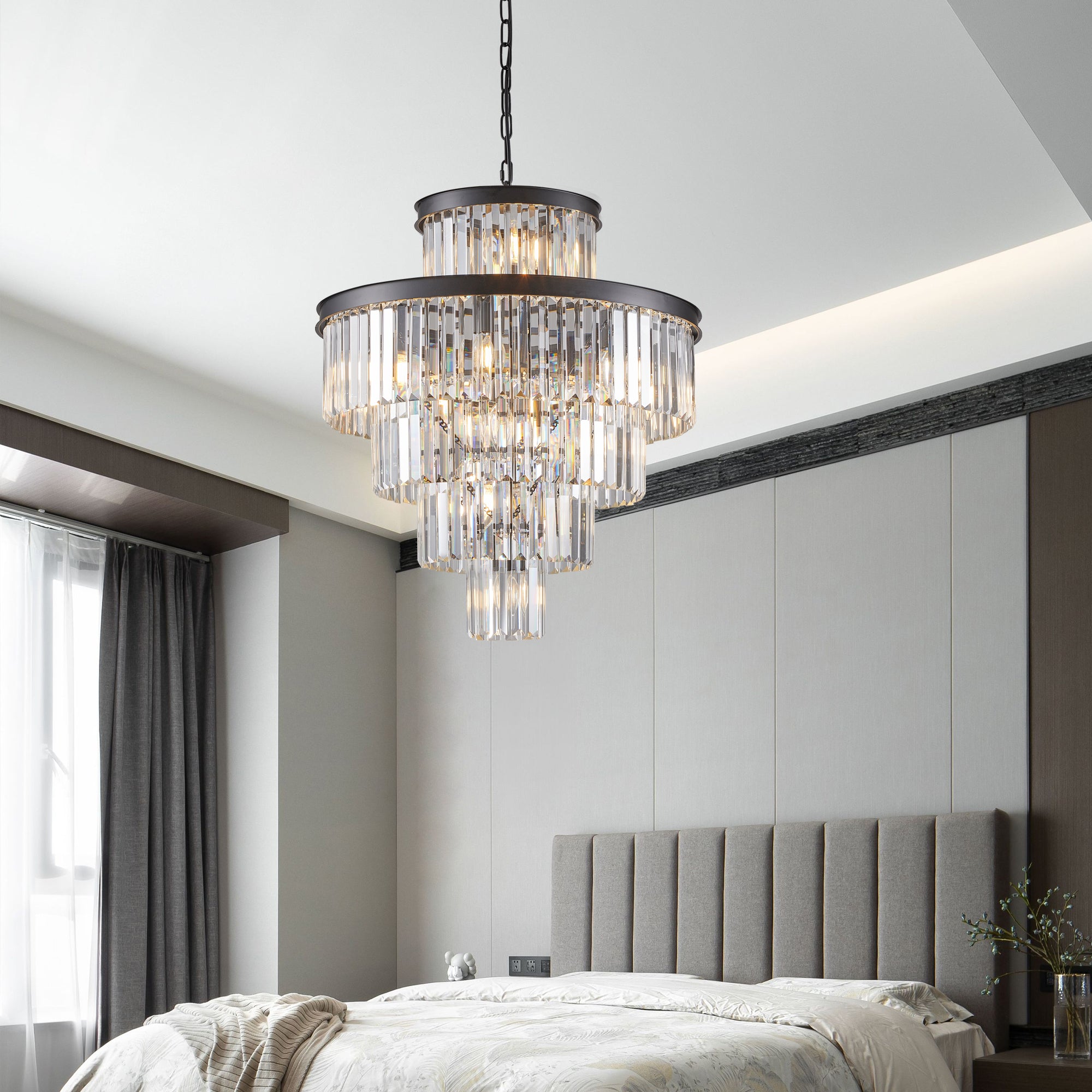 Chandelier hanging above a bed in a modern bedroom