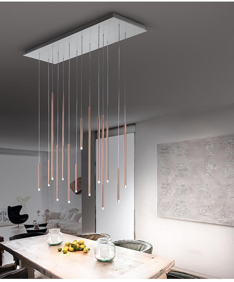 Contemporary dining space featuring Aurorae Lighting Clustered Tubes LED chandelier