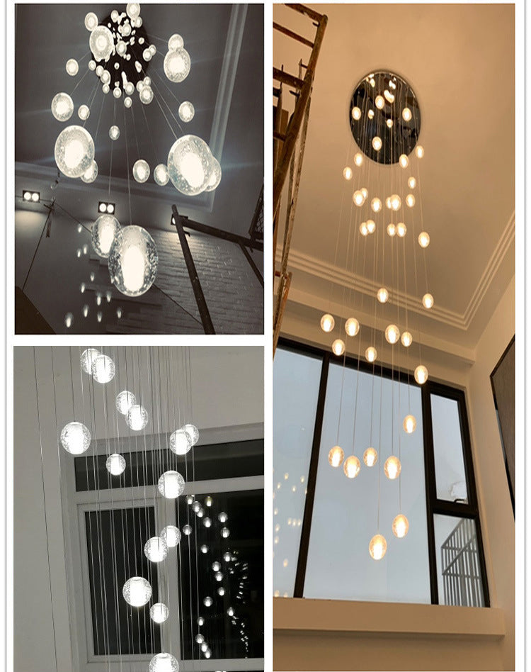 Warm light filtering through the cascading crystals of an Aurorae Lighting sphere chandelier