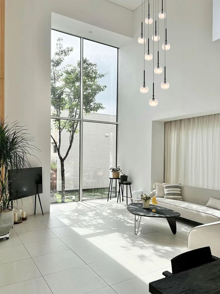 Gracing a stately foyer, Aurorae’s pendant light welcomes guests with its warm, elegant radiance.