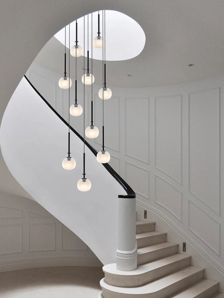 Suspended above a staircase, Aurorae’s pendant light guides with a gentle, luminous embrace.