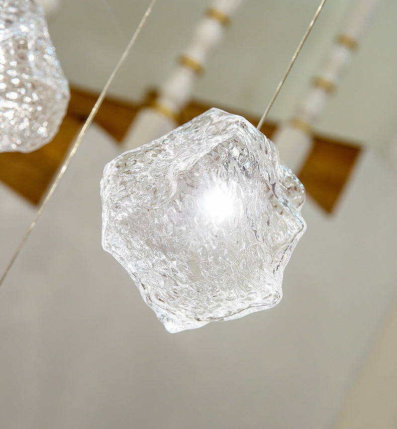 Close-up of a single Aurorae Lighting ice cube pendant showcasing the clarity and texture of the solid glass