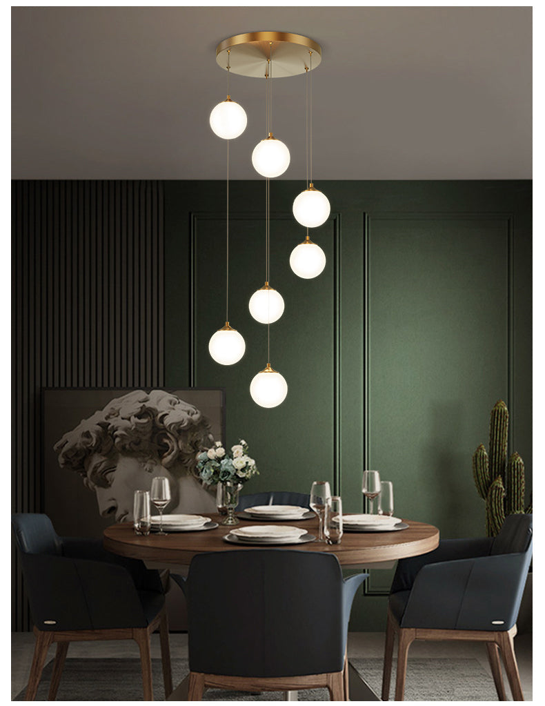 Modern milk white glass globe pendant light hanging over dining table