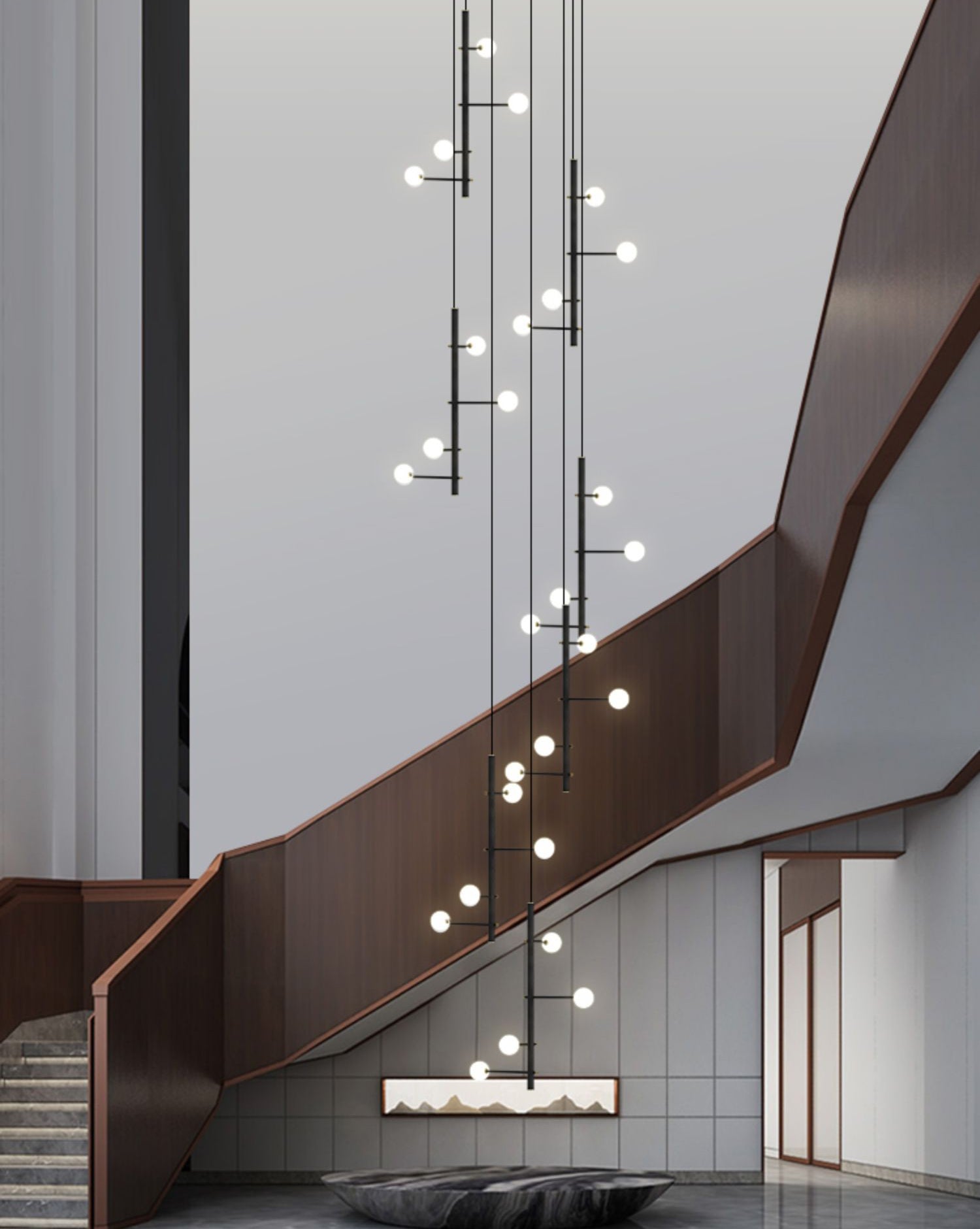 Close-up of the black multi-arm opal glass chandelier gracefully descending along a modern staircase.