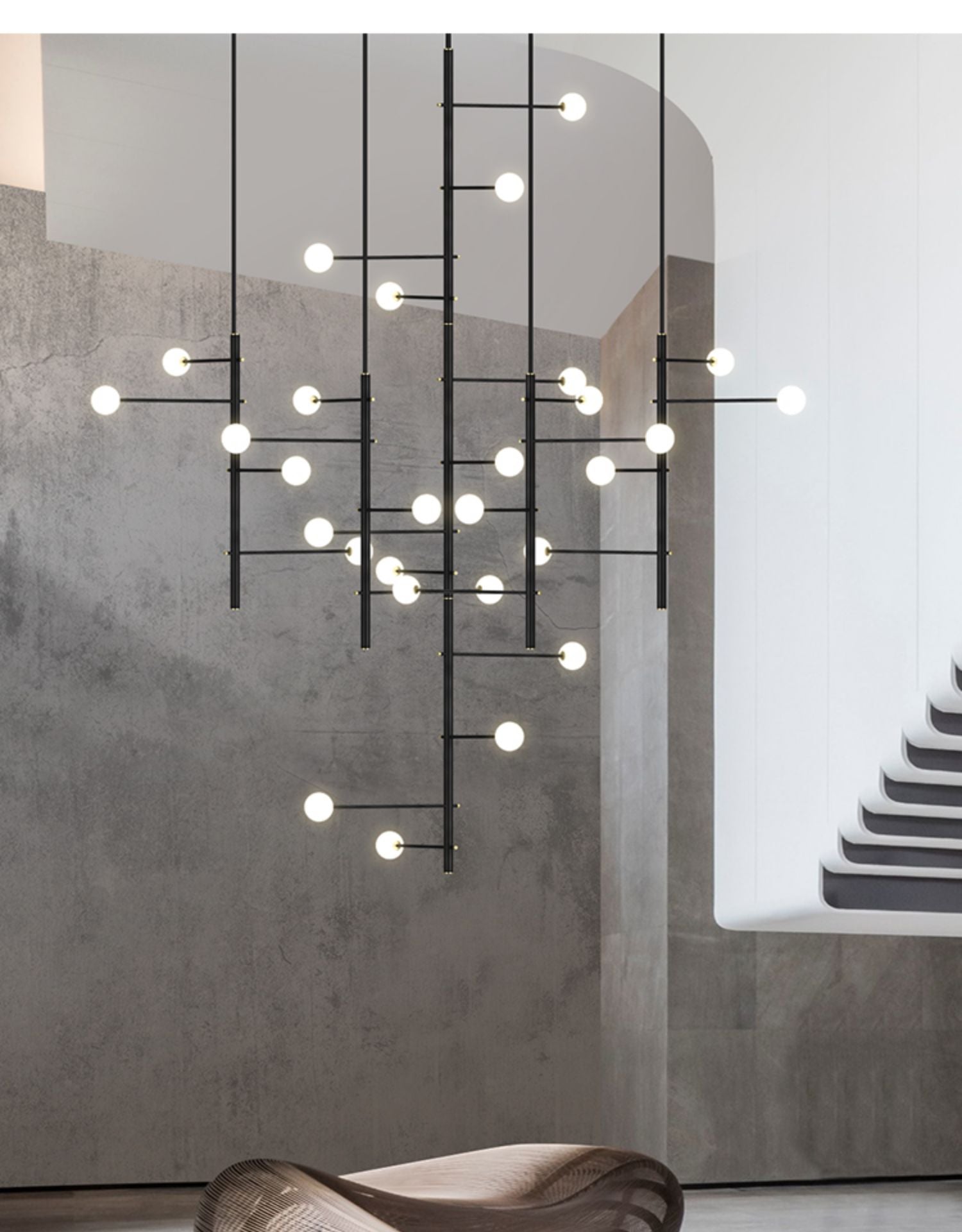 Black multi-arm opal glass chandelier installed along stairs, creating an artistic lighting feature.