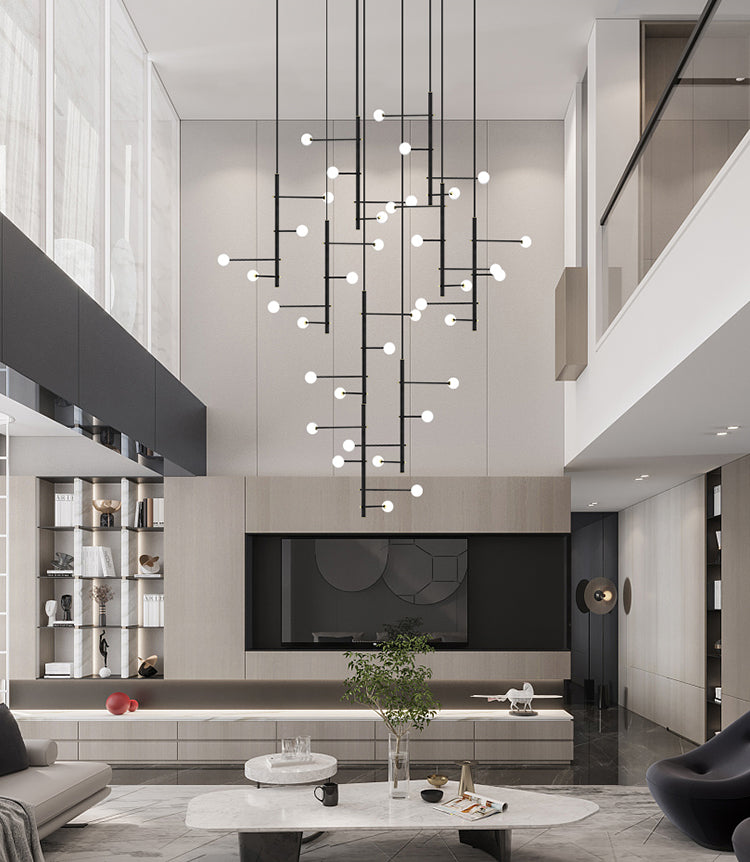 Modern living room featuring a long black multi-arm opal glass chandelier hanging above the seating area.