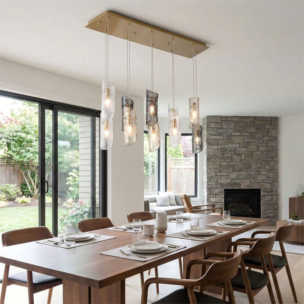 Modern dining room with wooden table, chairs, and pendant lights.