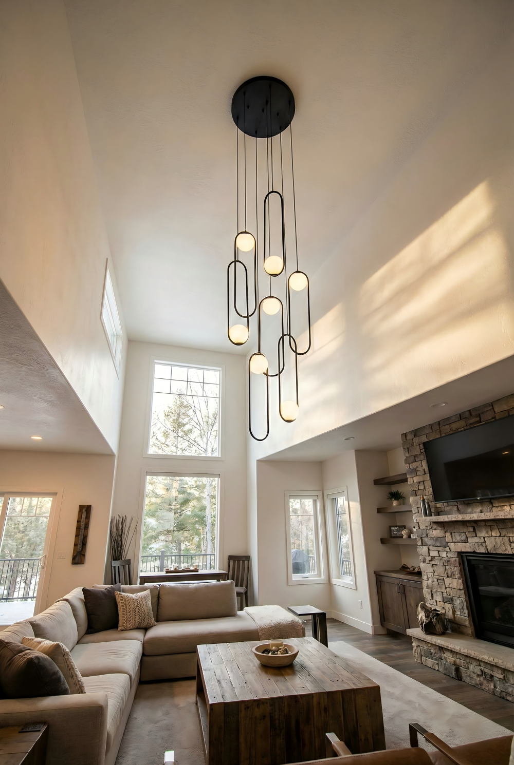 Opal glass globe chandelier centered in a modern living room with sectional sofa and floor-to-ceiling windows