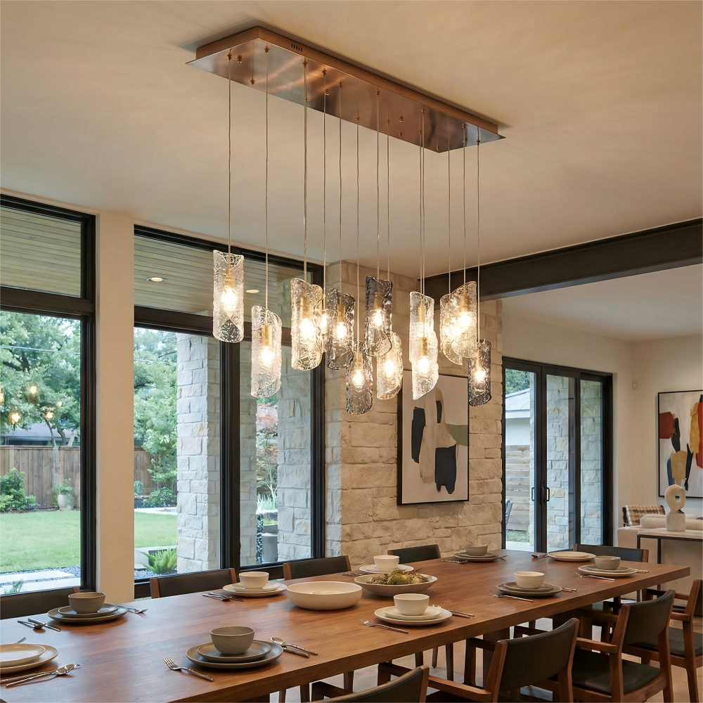 Dining room with a modern chandelier, wooden table, and chairs.
